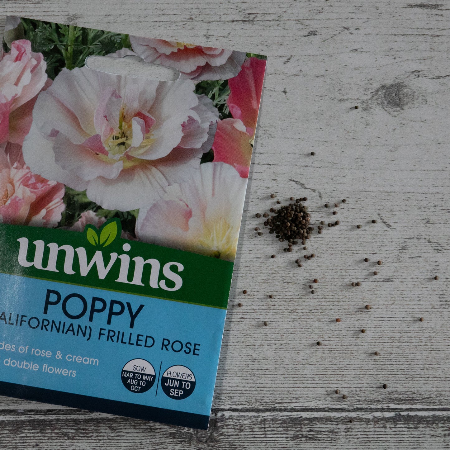 Unwins Californian Poppy Frilled Rose seeds pack on table with seeds